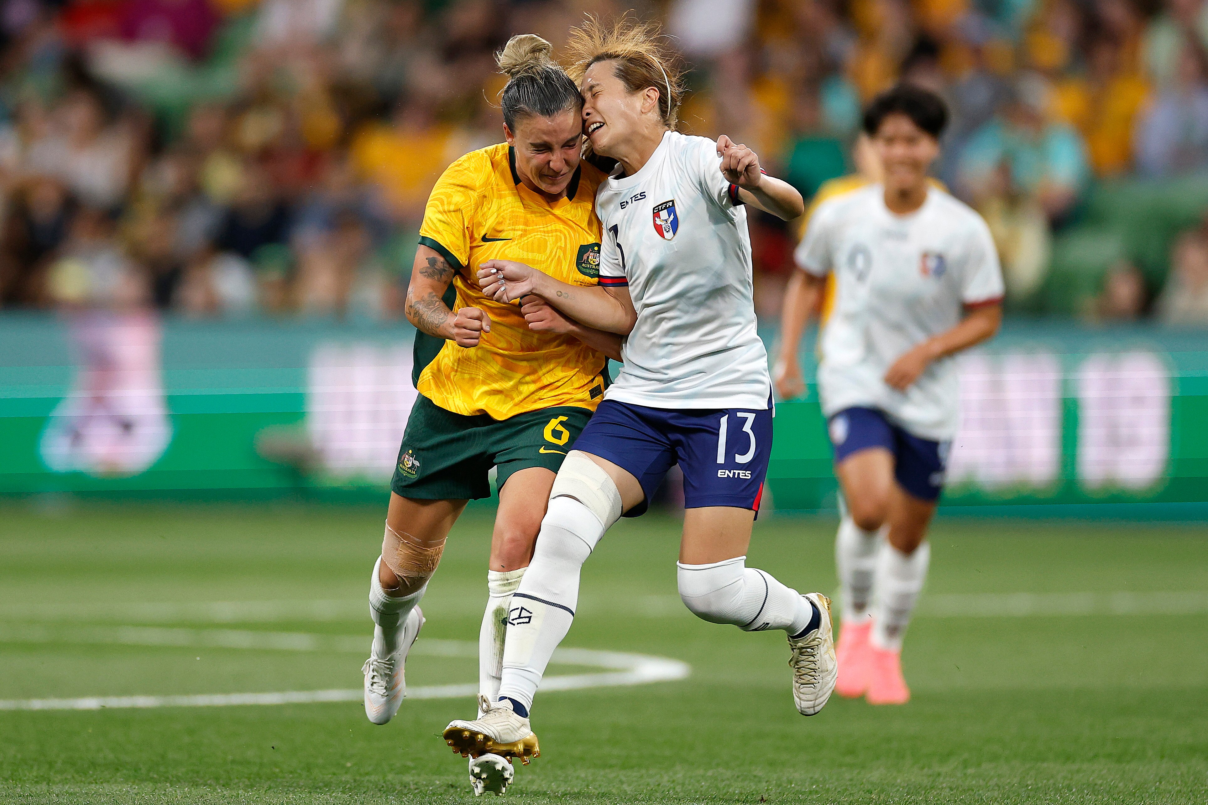 Matildas player Chloe Logarzo and Taiwan player Chan Pi-Han clash heads as they compete for the football.