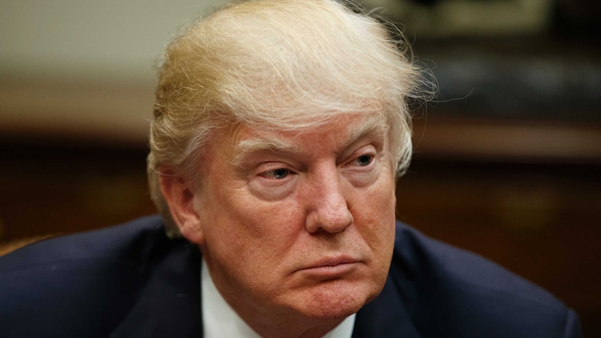 President Donald Trump listens during a meeting.