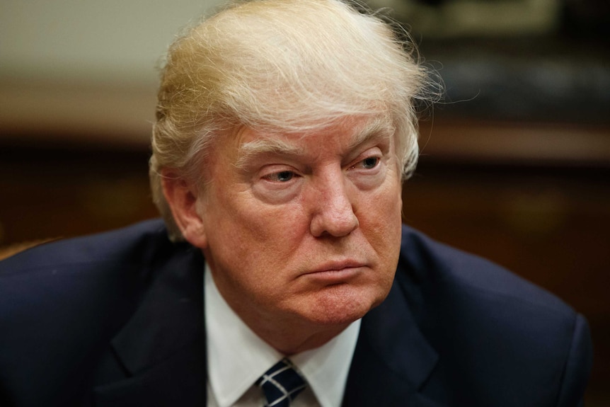 President Donald Trump listens during a meeting.