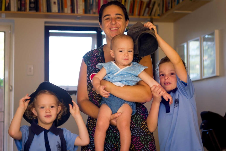 Sara Vogelsberger with her three children in their small apartment in West End.