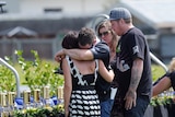 Disappointed... family members pay their respects following a public memorial service in 2011.