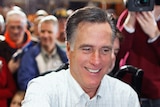 Former Massachusetts governor and Republican presidential candidate Mitt Romney greets supporters and gives autographs.
