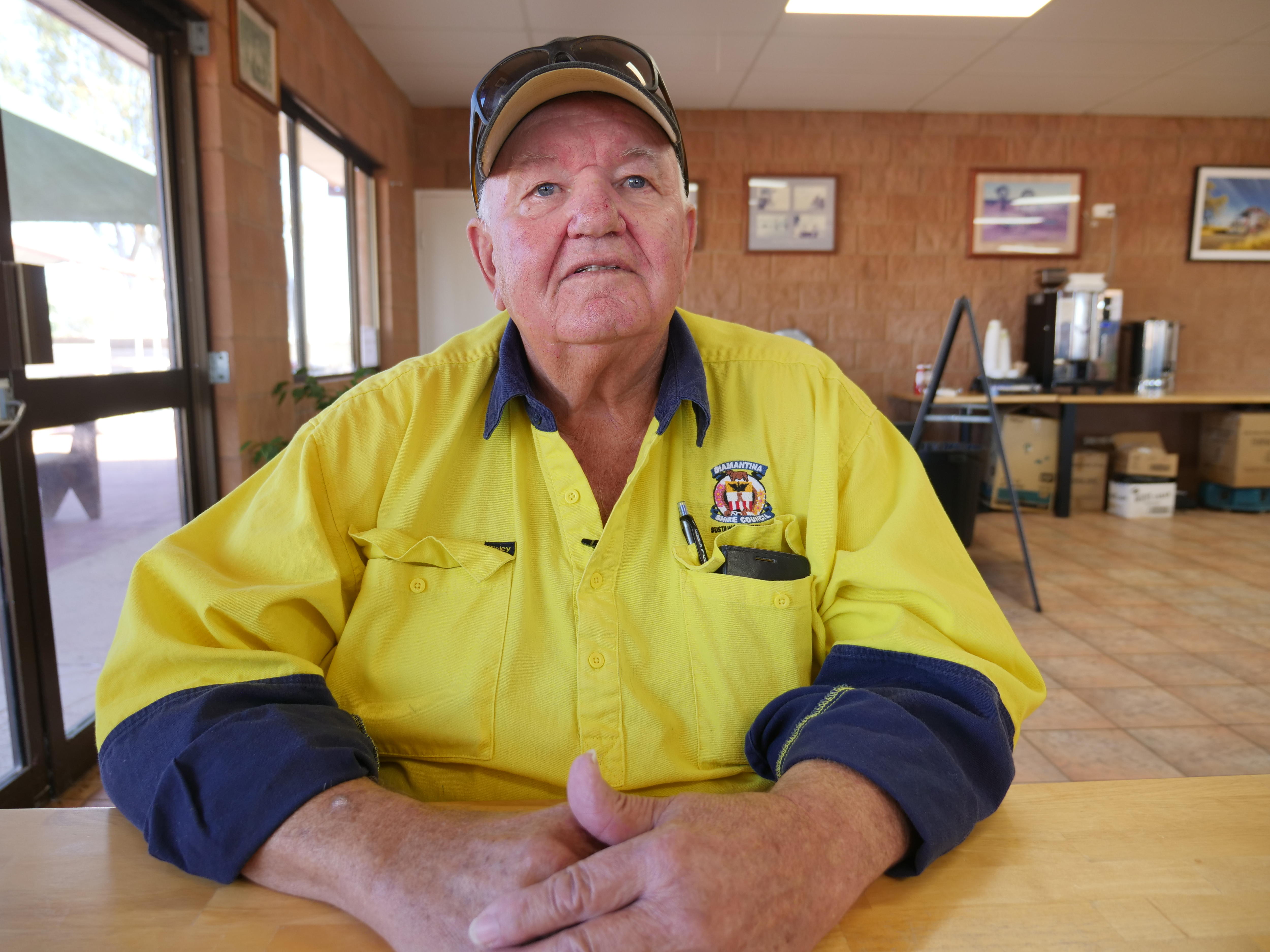 Man in yellow work shirt.