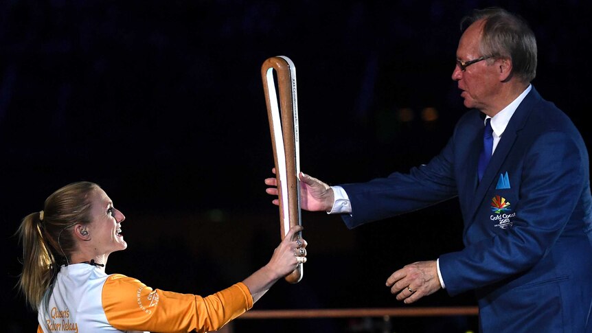 Sally Pearson hands the Queen's Baton to Peter Beattie