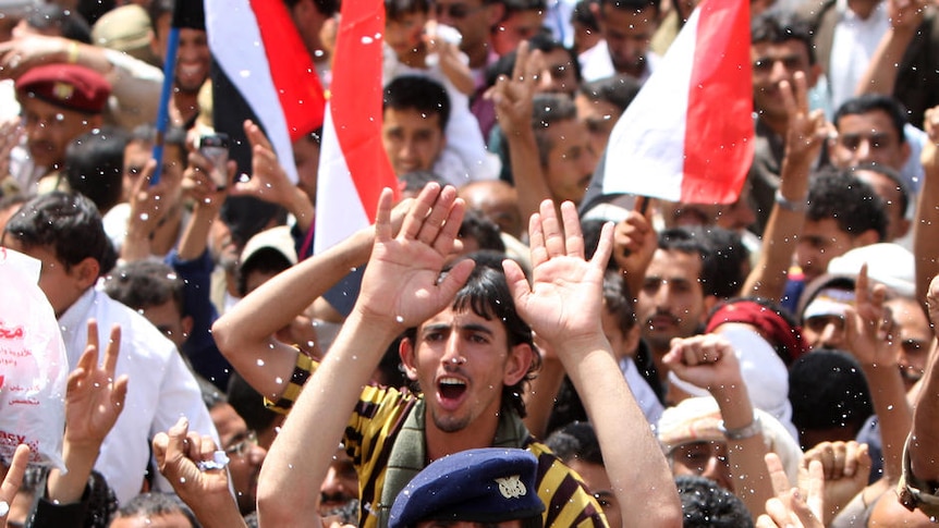 Yemeni anti-government protesters in Sanaa celebrate president Ali Abdullah Saleh leaving the country.