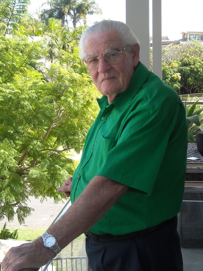 Man in green shirt on balcony