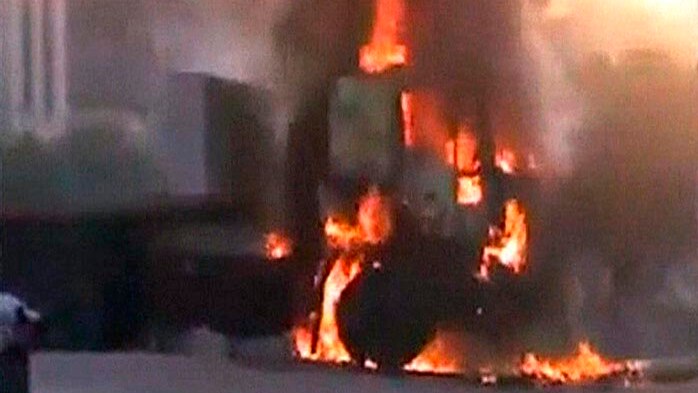 A vehicle burns as Syrian army storms the city of Hama