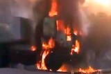 A vehicle burns as Syrian army storms the city of Hama