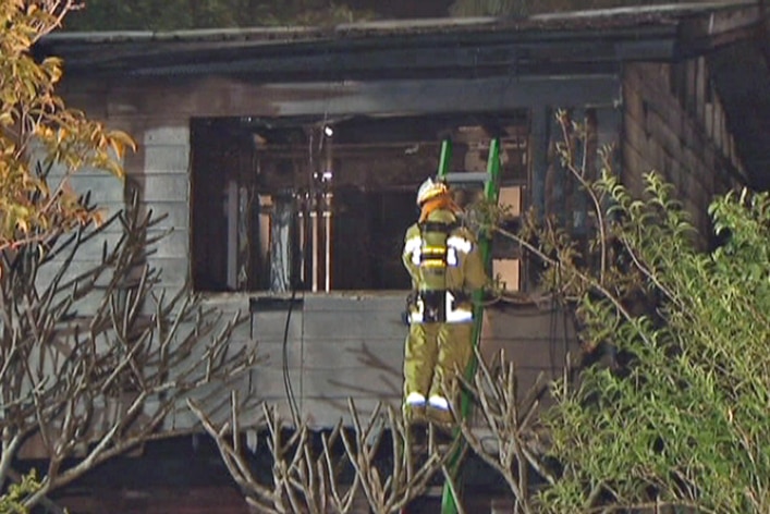 Firefighter at the scene of the house fire at Logan City
