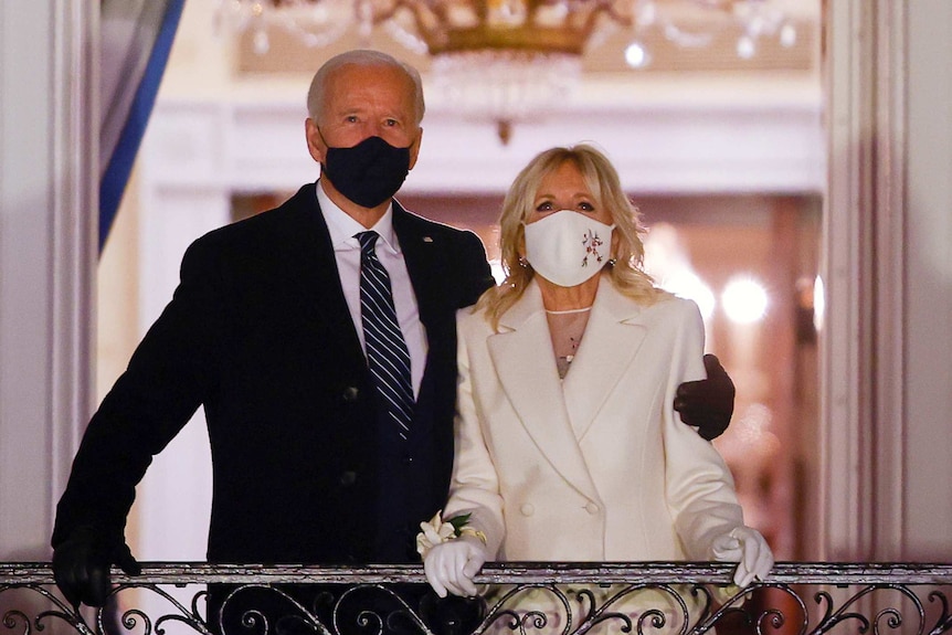 Joe Biden with his arm around his wife Jill Biden as they watch fireworks.