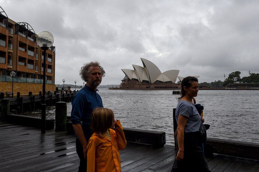 People walk round Sydney Harbour