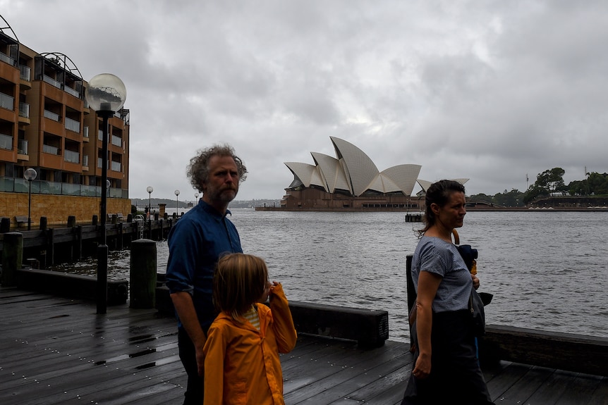 People walk round Sydney Harbour