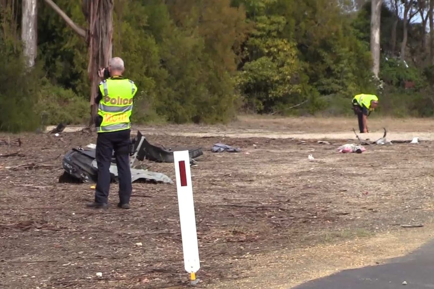 Police inspect the wreckage after a car crash in Lakes Entrance.