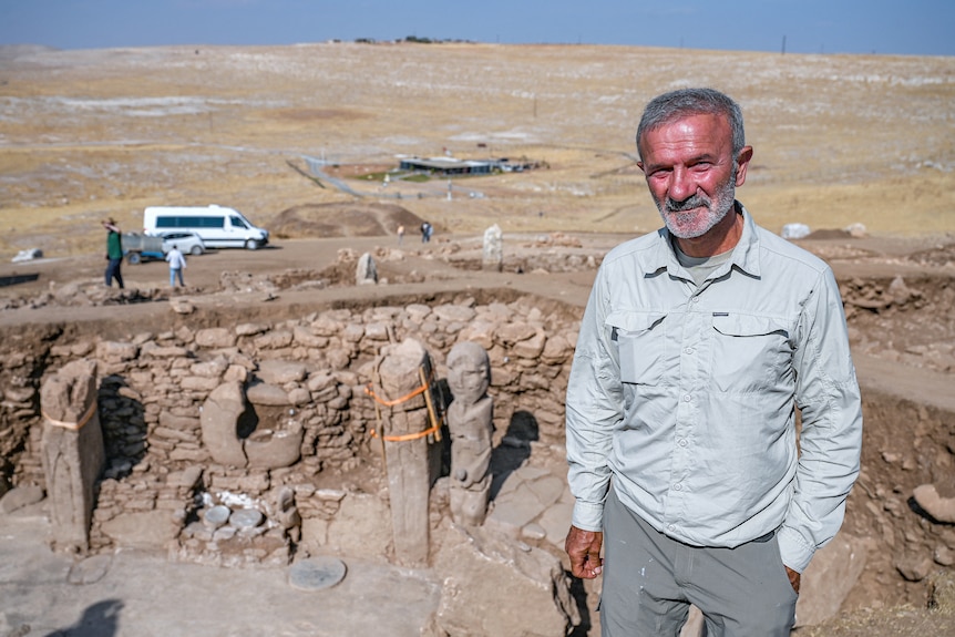 Necmi stands and poses for a photo at the dig site.