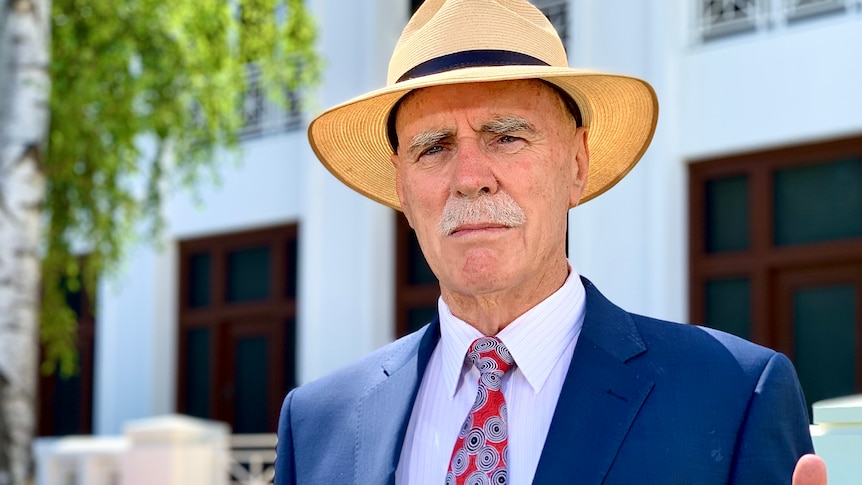 a man wearing a broad-brimmed hat and a suit