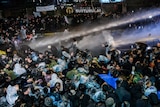 Turkish riot police use water cannon and tear gas to disperse supporters at Zaman daily newspaper headquarters in Istanbul