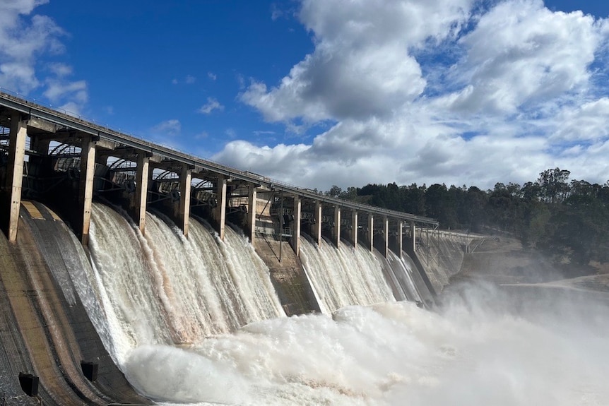 A large volume of water is released from a large dam.