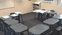 Desks and chairs a crowded and squashed into each other in a classroom at Parkville College.