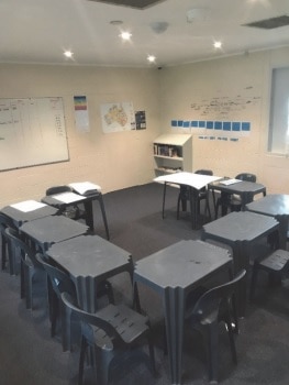Desks and chairs a crowded and squashed into each other in a classroom at Parkville College.