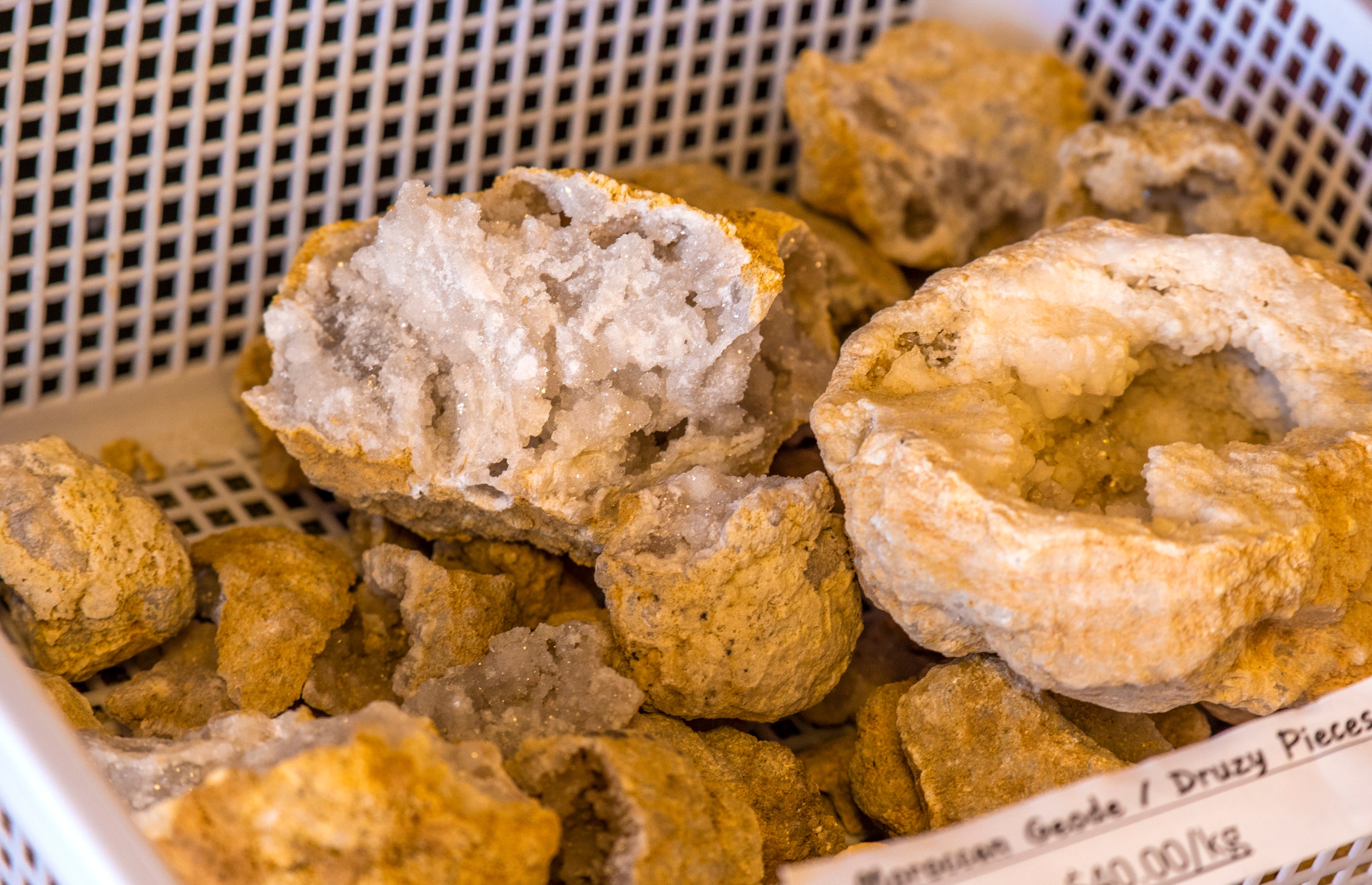 A basket of rocks cracked open to reveals the crystals.