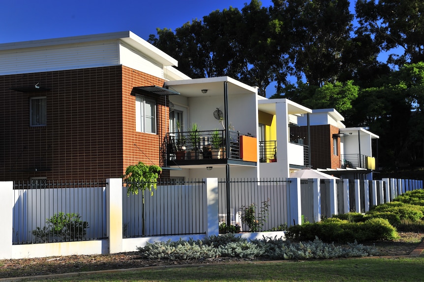 A wide shot of a two-storey public housing apartment complex in Perth.
