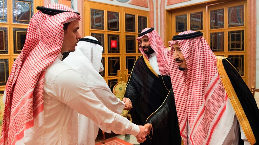 Saudi King Salman and Crown Prince Mohammed bin Salman shake hands with a son of Jamal Khashoggi and another family member.
