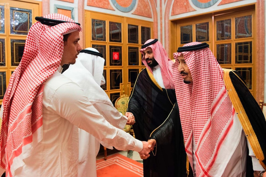 Saudi King Salman and Crown Prince Mohammed bin Salman shake hands with a son of Jamal Khashoggi and another family member.