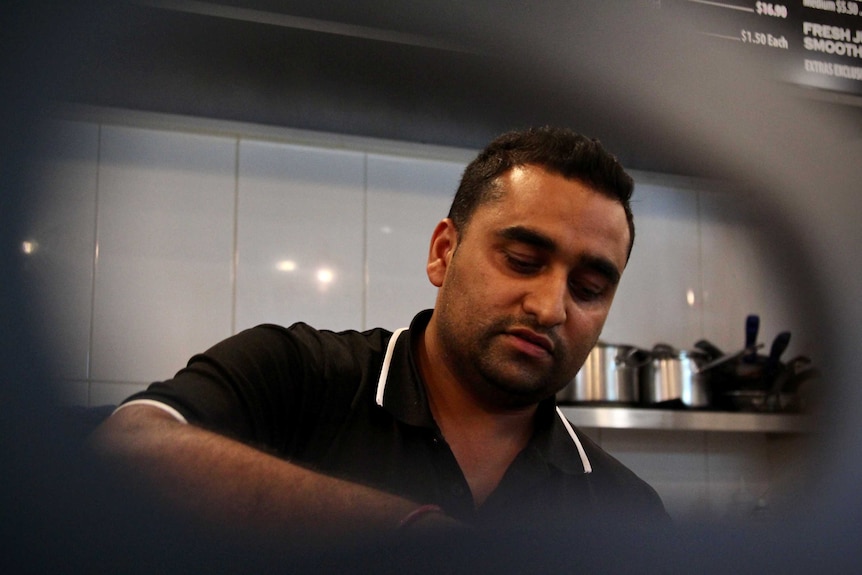 Singh works in his kitchen.