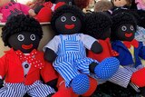 Several golliwog dolls on display at a market stall