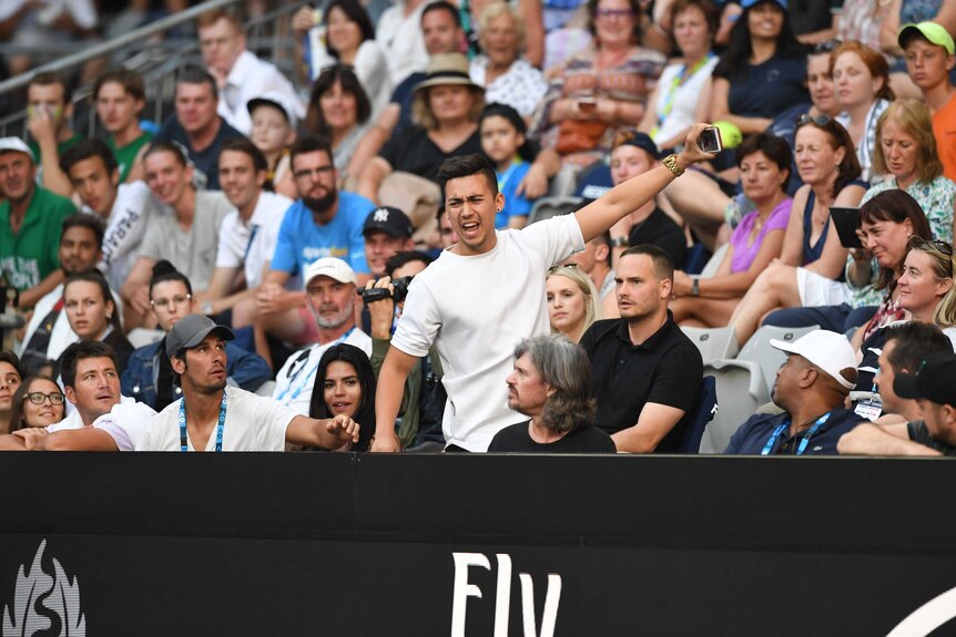 A spectator is seen hackling during the Nick Kyrgios versus Viktor Troicki match at the Australian Open.