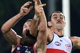 Taylor Walker (right) and Max Gawn contest for the ball as they collide in the air.