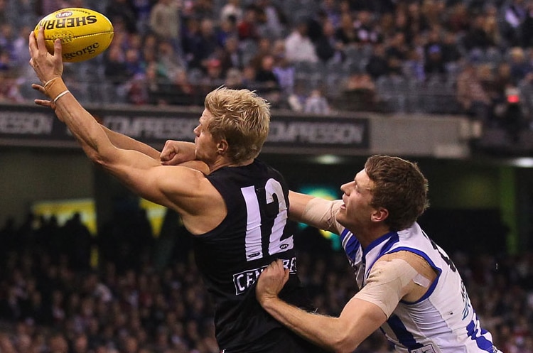 St Kilda's Nick Riewoldt marks the ball in front of the Kangaroos' Lachlan Hansen at Docklands.