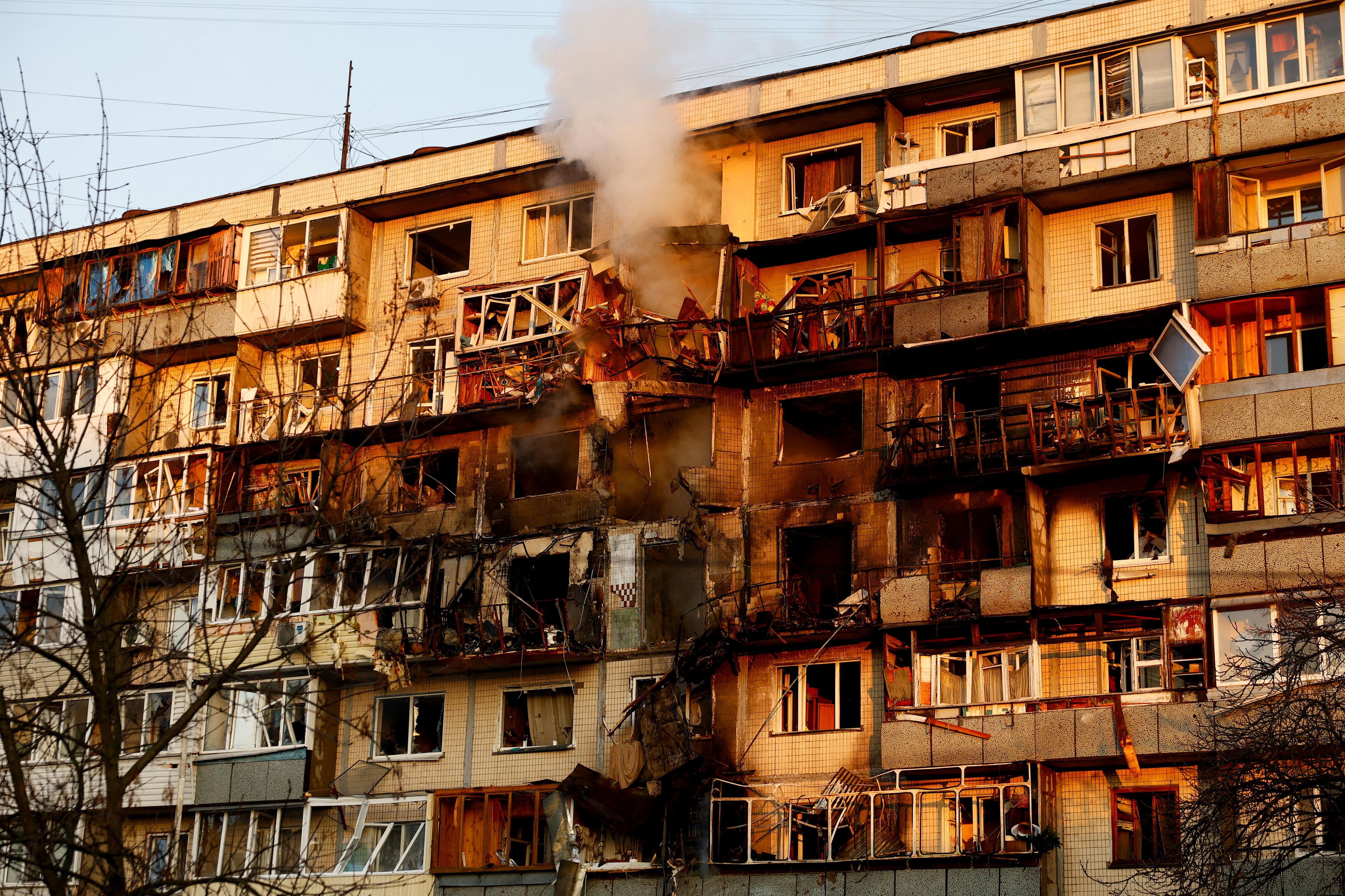 Smoke rises from a damaged apartment building