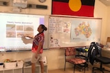 A teacher points to a projector to introduce Noongar words to a class of students