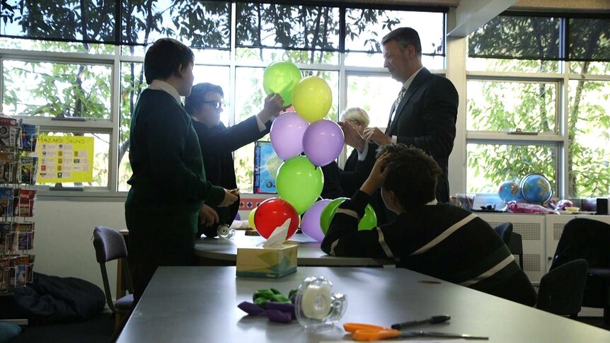 Members of The Mutants build balloon towers as part of an exercise in their mentoring session.