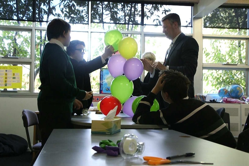Members of The Mutants build balloon towers as part of an exercise in their mentoring session.
