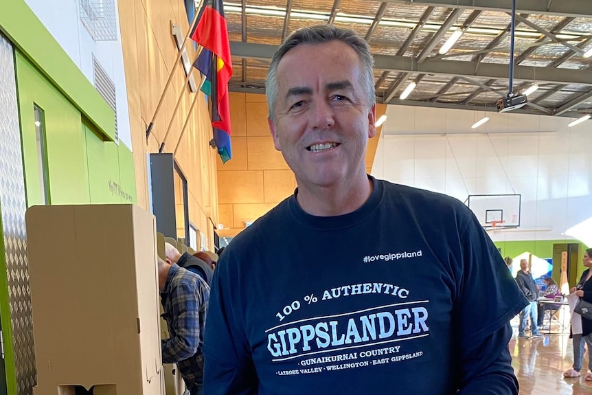 man with top on which says one hundred per cent authentic gippslander 