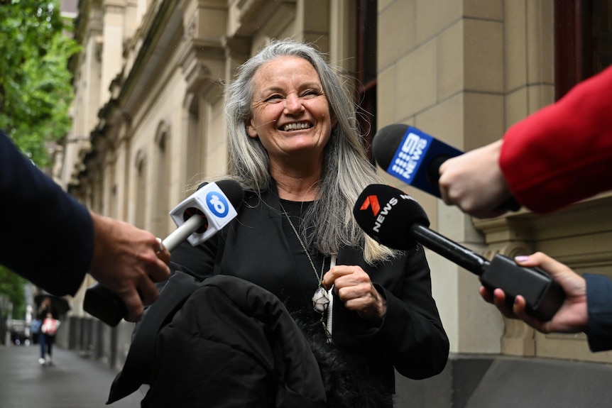 A woman being interviewed outside court