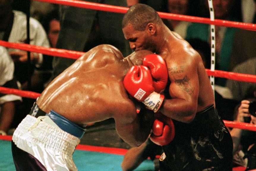 Mike Tyson bites the ear of Evander Holyfield during the third round of the WBA Heavyweight Championship fight in Las Vegas