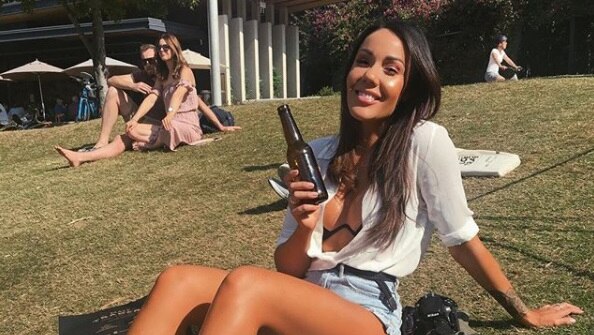 Davina Rankin relaxes on the grass in Brisbane
