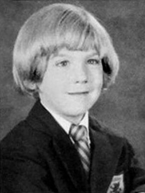 A black and white school portrait of a little blonde boy 