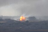 A dramatic explosion is seen over the Syrian town of Ras al-Ain.