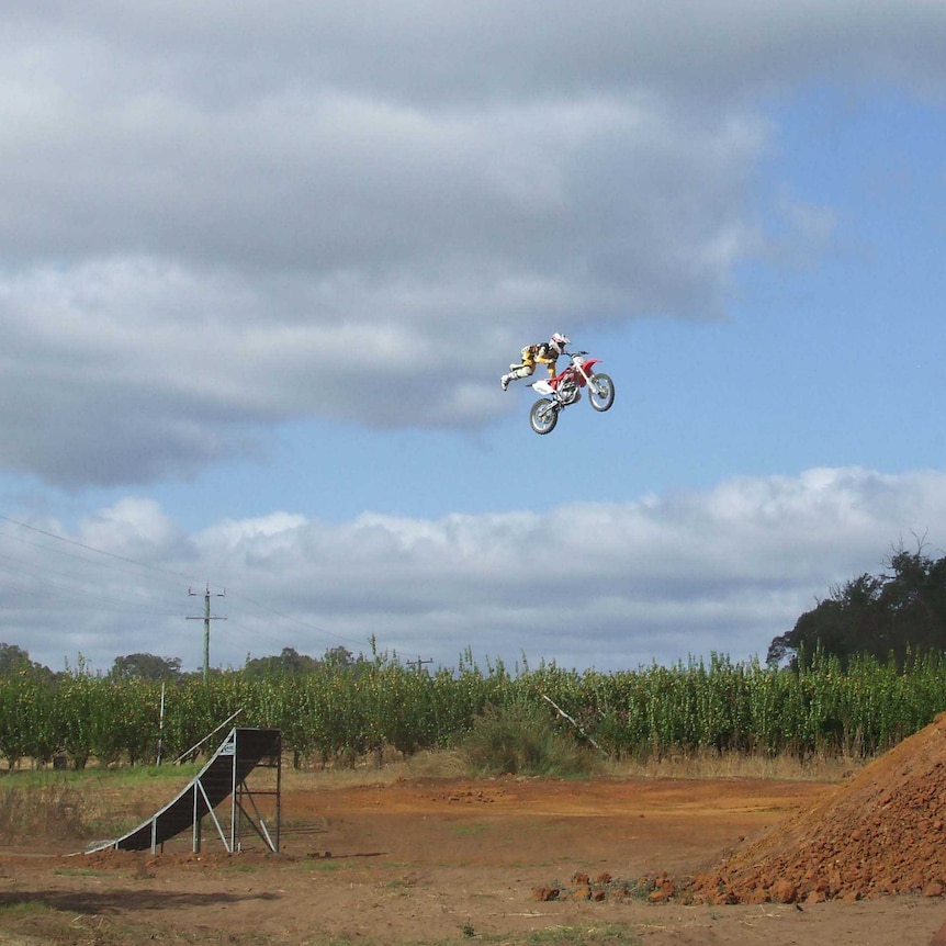 Flying high in the sky at the apple orchard in Donnybrook, world motocross champion Josh Sheehan practises