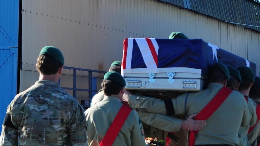Soldiers carry the casket of Sergeant Todd Langley.