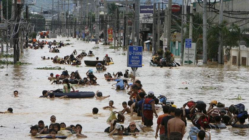 Residents wade in floodwaters caused by Typhoon Ondoy in the Philippines