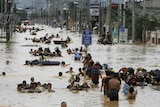 Residents wade in floodwaters caused by Typhoon Ondoy in the Philippines
