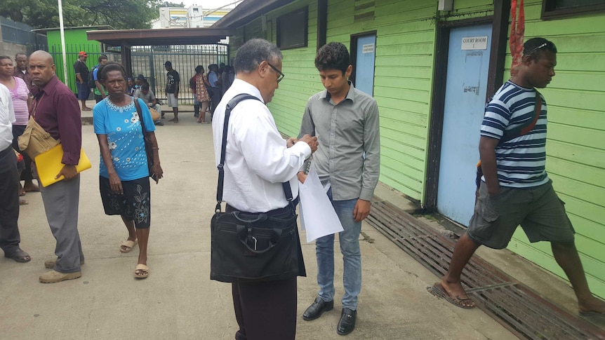 Loghman Sawari, the Iranian refugee who fled PNG for Fiji, outside court with his lawyer Loani Henao.