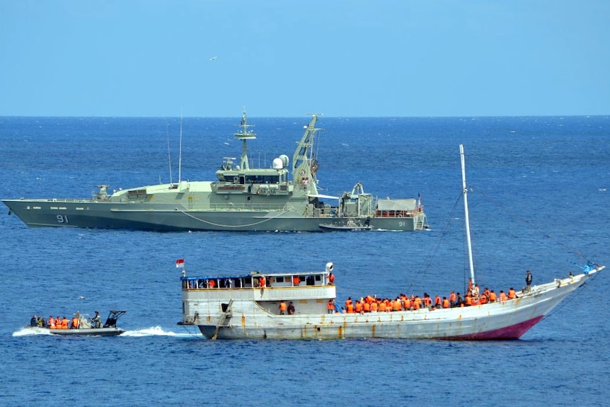 An Australian Navy vessel moored near an asylum seeker boat