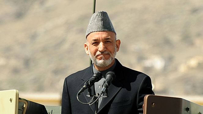 Afghan President Hamid Karzai stands atop a vehicle during parade of the Afghan military