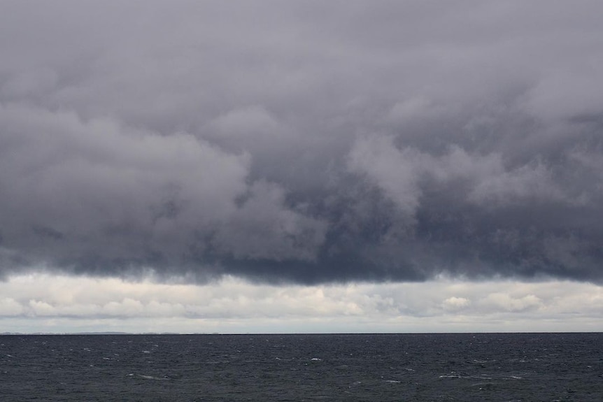 Dark storm clouds just above the horizon on Port Phillip.